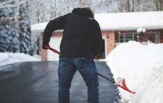 Man clearing snow from road
