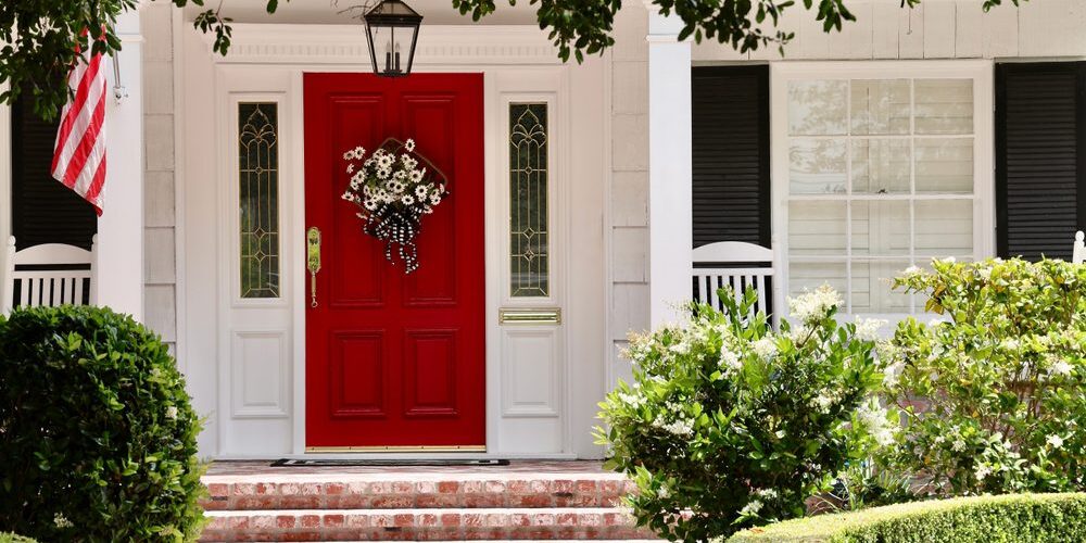 Elegant white house with bright red front door