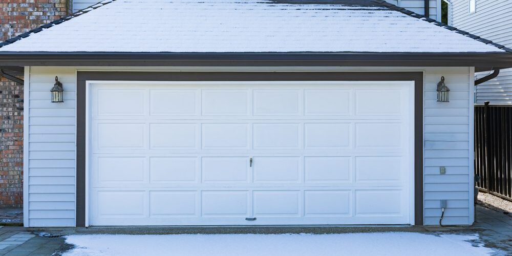 Garage Door. Modern house with white garage door that is closed. A perfect neighborhood. Family house with wide garage door and concrete driveway in front. Street photo, nobody