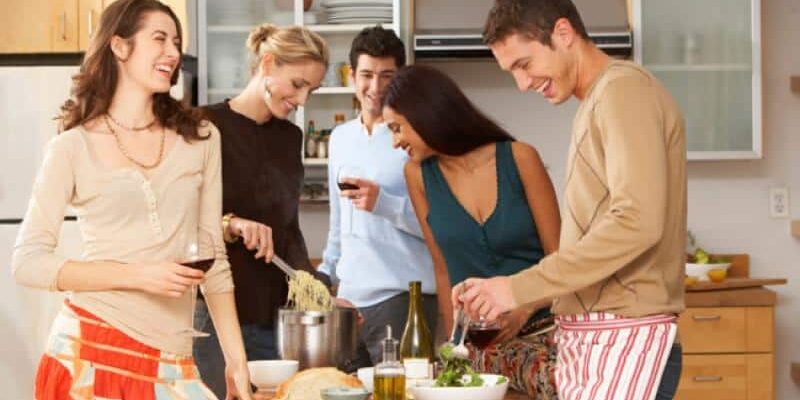 Group laughing in kitchen